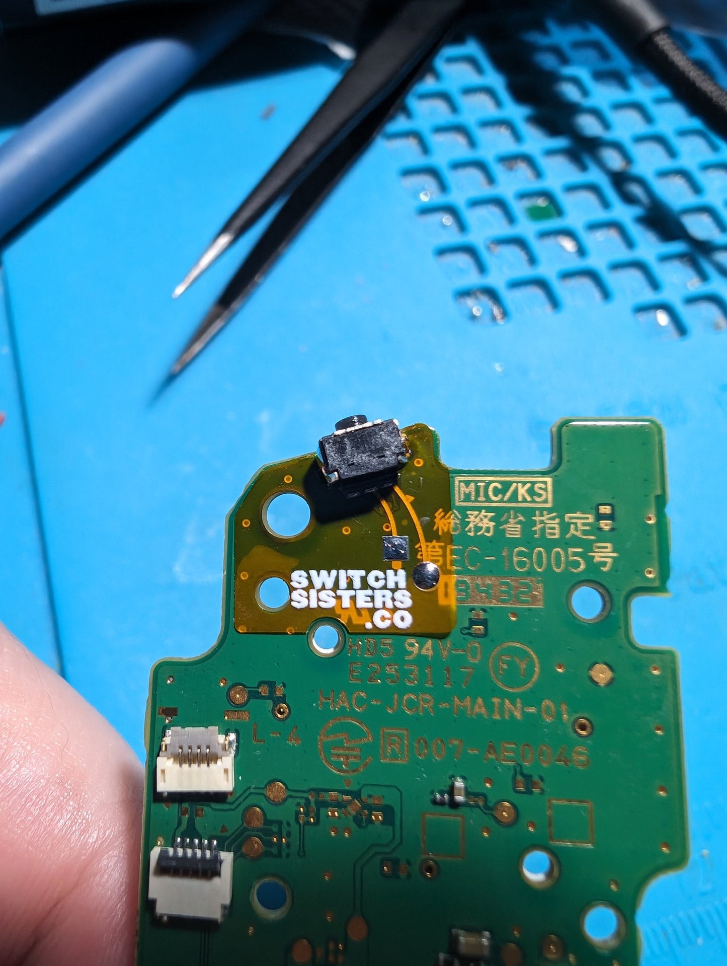 A close-up image of a green circuit board designed for Joy-Con R Button repair, with a focus on the area containing the R button connectivity components.
